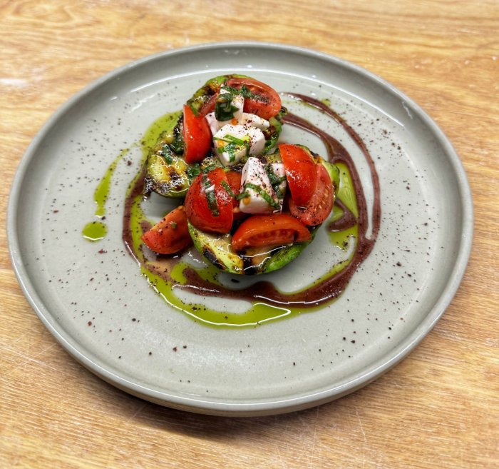 Grilled avocado with cherry tomatoes and vegan feta cheese